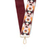 Patterned strap with gold clasp on a white background