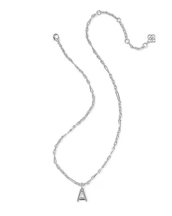 Gold necklace with a letter 'G' pendant on a white background
