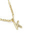 Gold necklace with a 'K' pendant on a white background