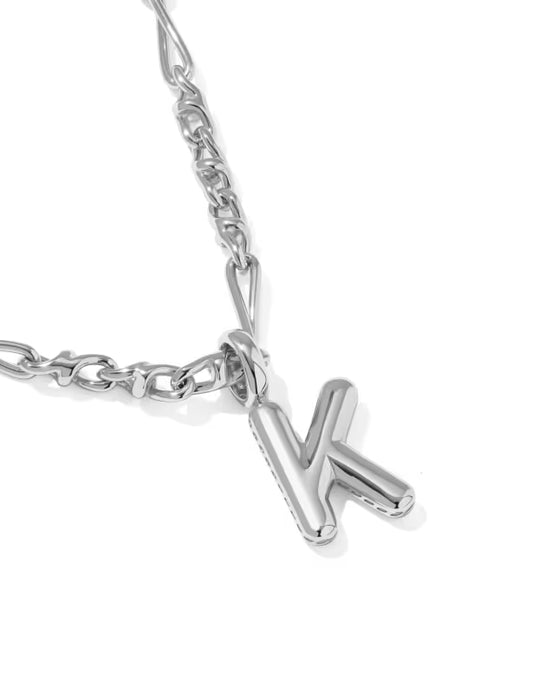 A silver initial necklace featuring a polished capital letter 'K' pendant hanging from a classic curb chain, shown on a clean white background.