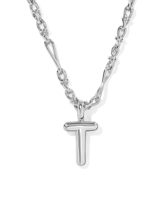 A silver necklace featuring a polished T-shaped initial pendant on a multi-link chain, shown against a plain white background.
