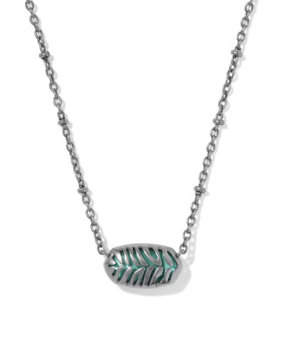 A silver-toned chain necklace featuring an oval pendant with a textured, leaf-like pattern filled with turquoise green inlay, shown against a plain white background.