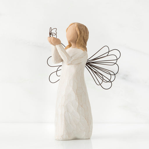 Angel figurine with outstretched wings on a white background
