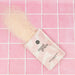 Sweet Grace mineral soaping salts packaging on a pink tiled background