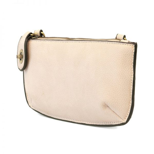 Beige handbag with a gold zipper on a white background