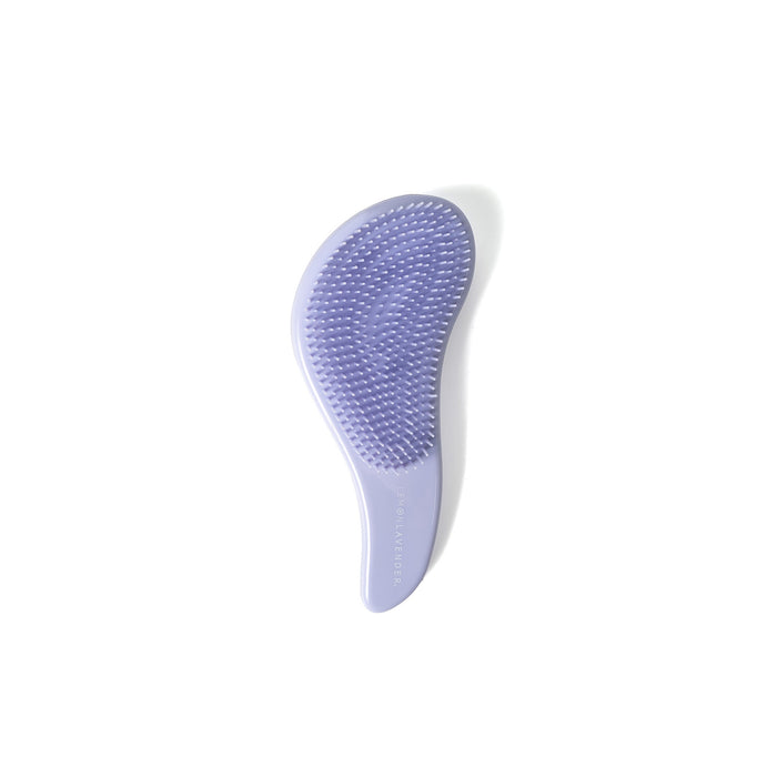 Purple grooming brush on a white background