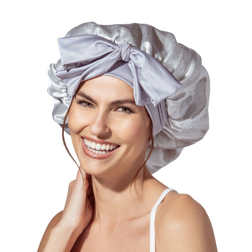 Woman wearing a silver satin bonnet on a white background
