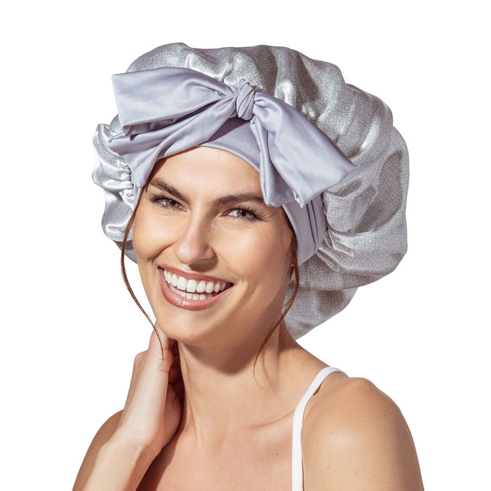 Woman wearing a silver satin bonnet on a white background