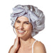 Woman wearing a silver satin bonnet on a white background