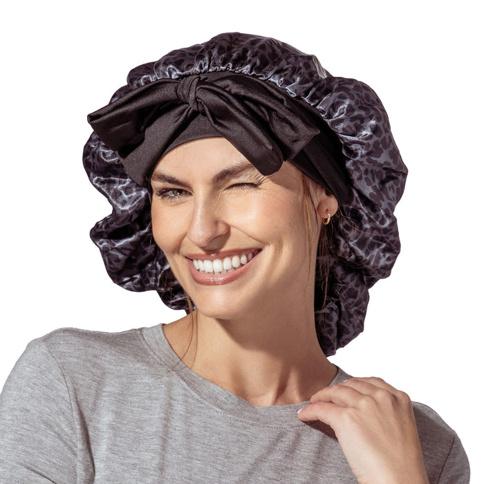 Woman wearing a black satin bonnet on a white background