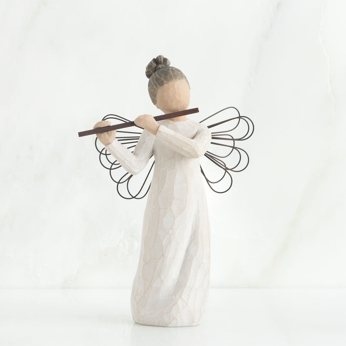 Angel figurine with outstretched wings on a white background