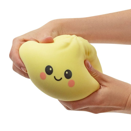Hands squeezing a large squishy dumpling