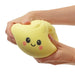 Hands squeezing a large squishy dumpling