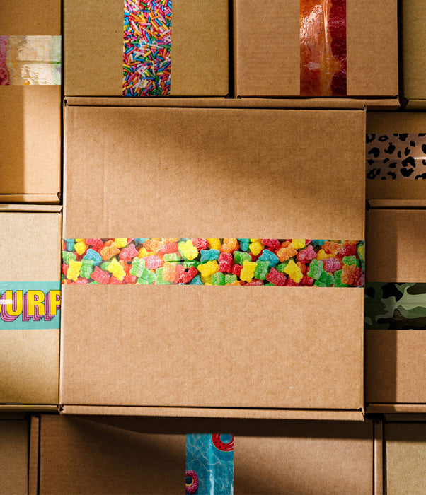Stack of cardboard boxes with colorful tape on a wooden surface