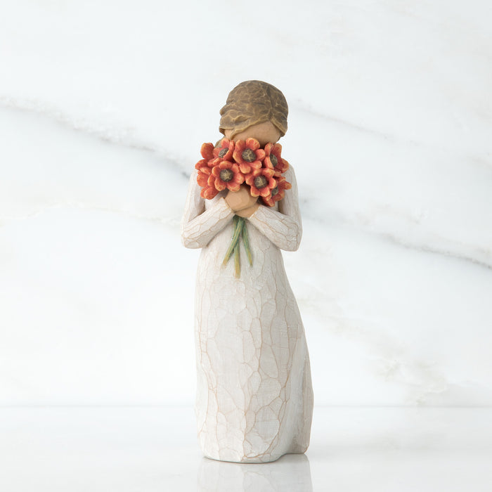 Statue of a woman holding flowers on a white background