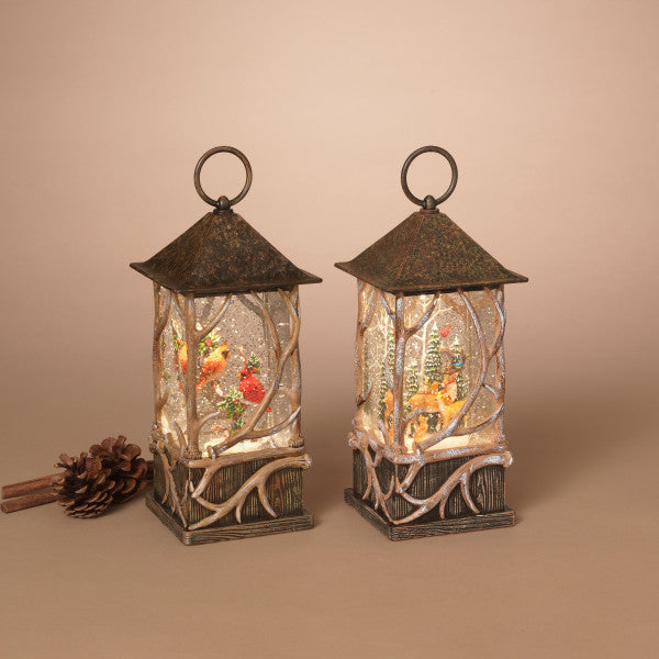 Two decorative lanterns with a winter scene inside on a beige background