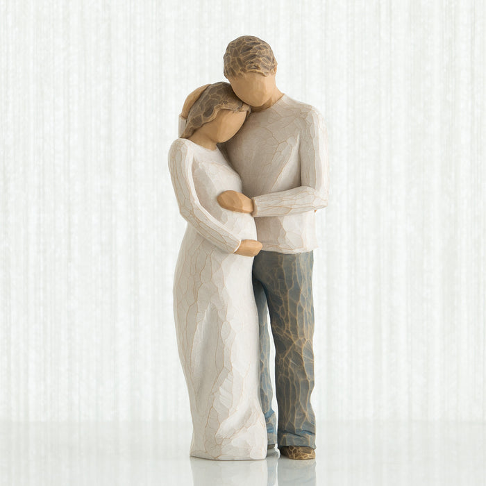 Statue of a couple embracing on a white background