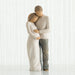 Statue of a couple embracing on a white background