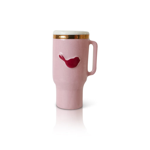 Pink travel mug with a red bird design on a white background