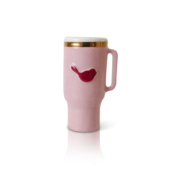Pink travel mug with a red bird design on a white background