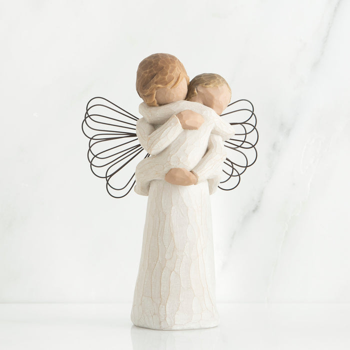 Decorative figurine of two angels hugging with a white background