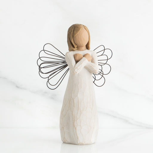 White angel figurine with wire wings on a white background