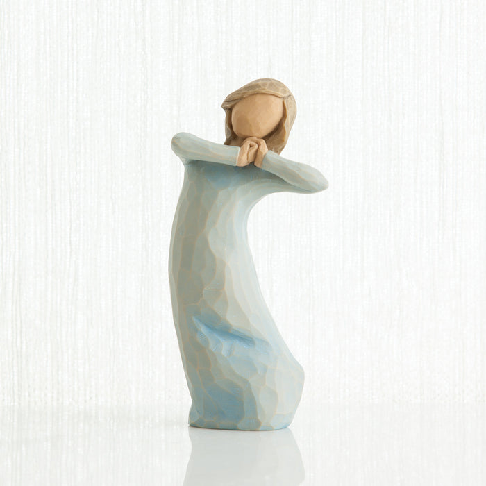 Decorative figurine of a woman holding a child on a white background
