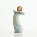 Decorative figurine of a woman holding a child on a white background