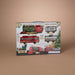 Packaged toy train set with Christmas-themed design on a beige background