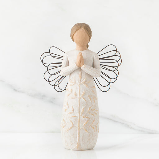 Standing angel in cream dress with wire wings, with hands in prayer position; tree carving on angel's dress