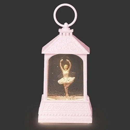Pink lantern with a ballerina figure inside on a dark background