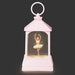 Pink lantern with a ballerina figure inside on a dark background