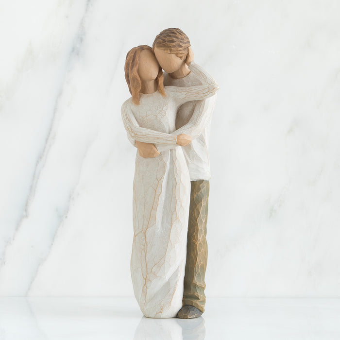 Statue of a couple embracing on a white background