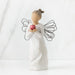 Standing angel in cream dress with wire wings, holding large, shiny red apple in outstretched hands