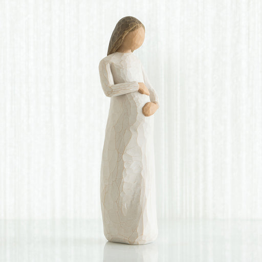 Statue of a woman holding a baby on a white background
