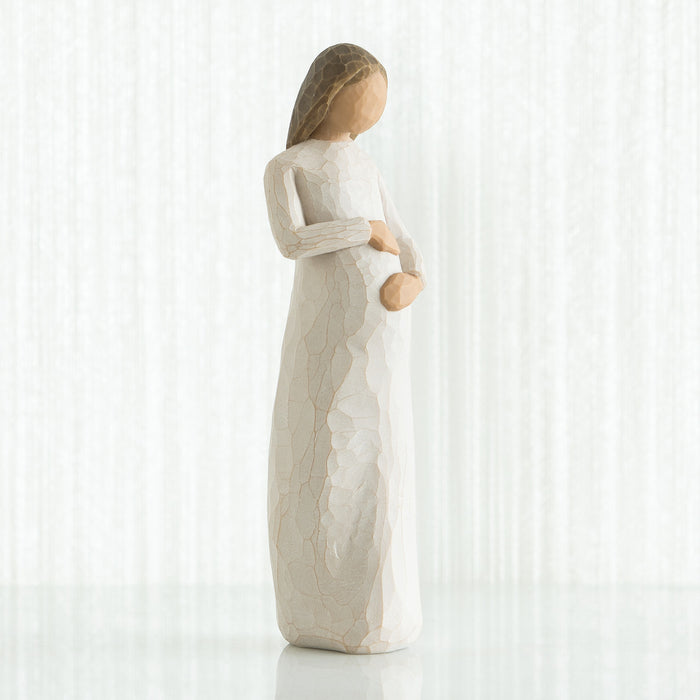Statue of a woman holding a baby on a white background