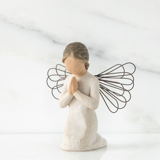 Angel figurine with wire wings on a white background