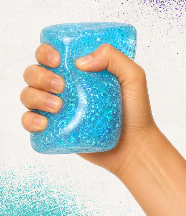 Hand holding a blue glittery jar against a white background