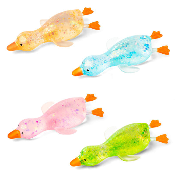 Four translucent duck-shaped stress toys arranged on a white background, each in a different color: yellow, light blue, pink, and bright green, with glitter inside and orange beaks and feet.