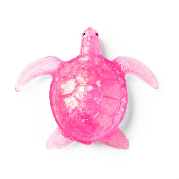 A translucent pink sea turtle toy or decorative figure with a glittery finish, shown from a top-down view on a plain white background.
