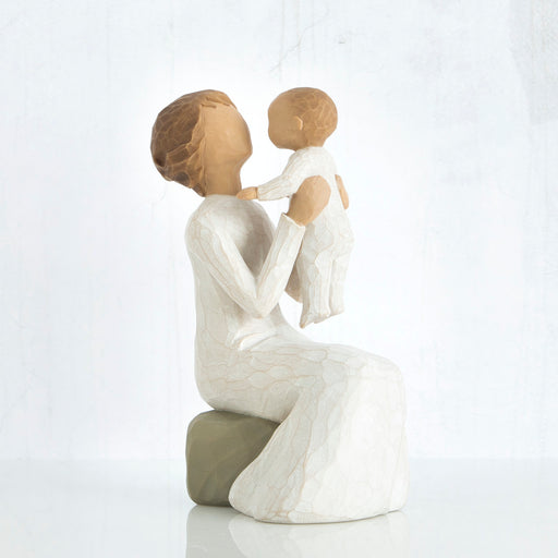 Statue of a woman holding a child on a white background