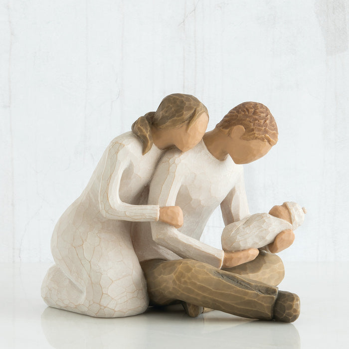 Statue of a woman embracing a child on a white background
