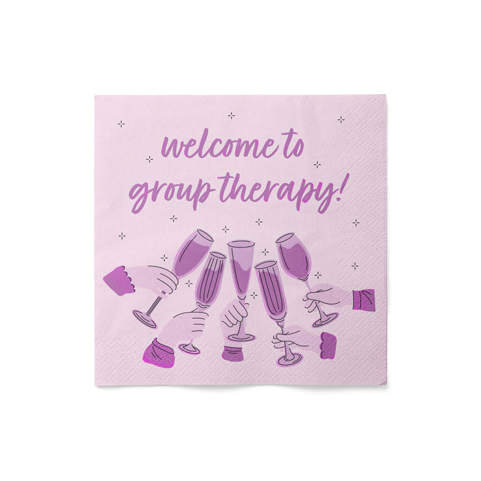Napkin with 'welcome to group therapy!' text and champagne glass illustrations on a pink background