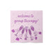 Napkin with 'welcome to group therapy!' text and champagne glass illustrations on a pink background
