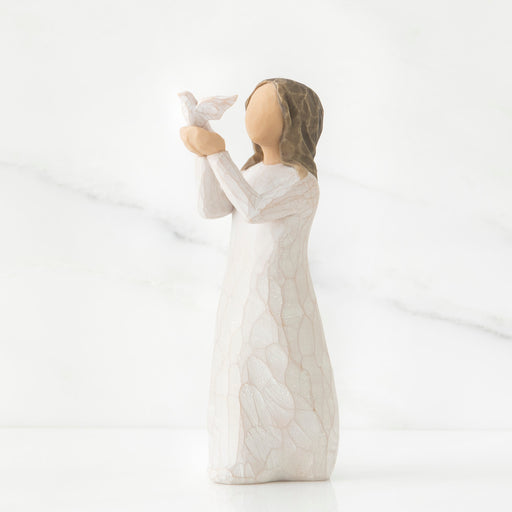 White ceramic figurine of a woman holding a rabbit on a white background