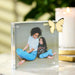 Acrylic photo block with butterfly decoration featuring a photo of two people sitting together.