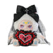 Toy doll with white hair, black bow, and red heart emblem on a white background