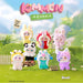 Collection of colorful plush toys with 'Kimmon' branding on a grassy background