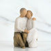 Statue of a couple embracing on a marble surface