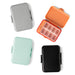 Four pillboxes in different colors on a white background